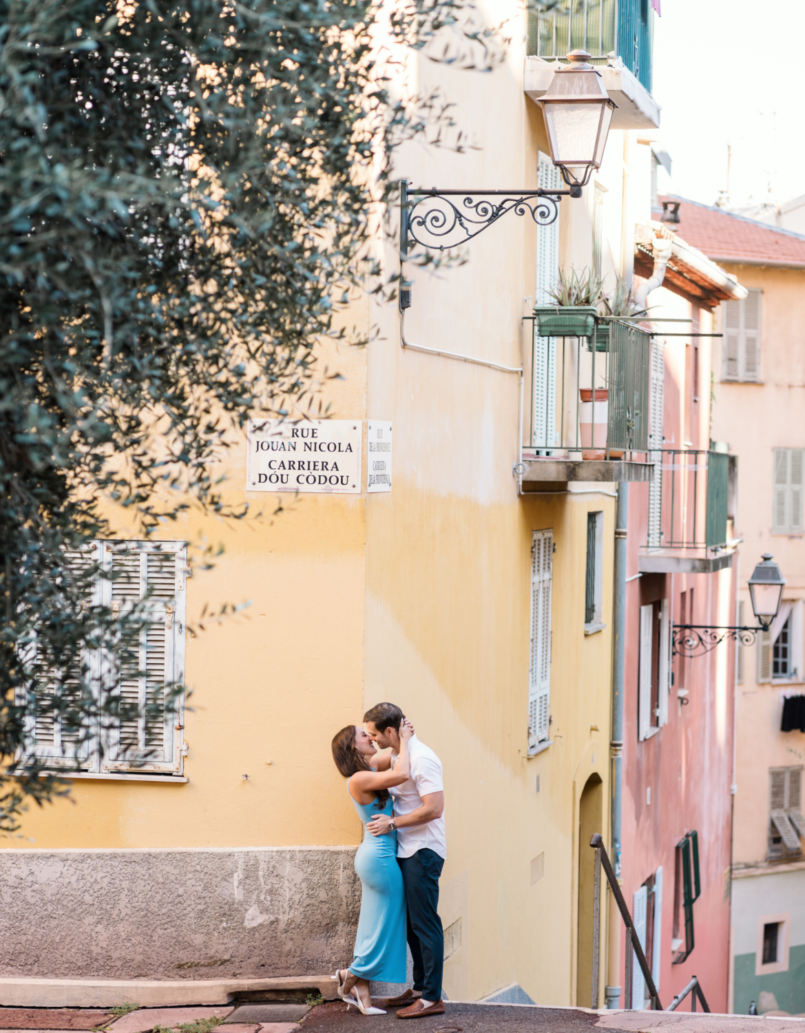 newlyweds in a passionate embrace on colorful street in nice france