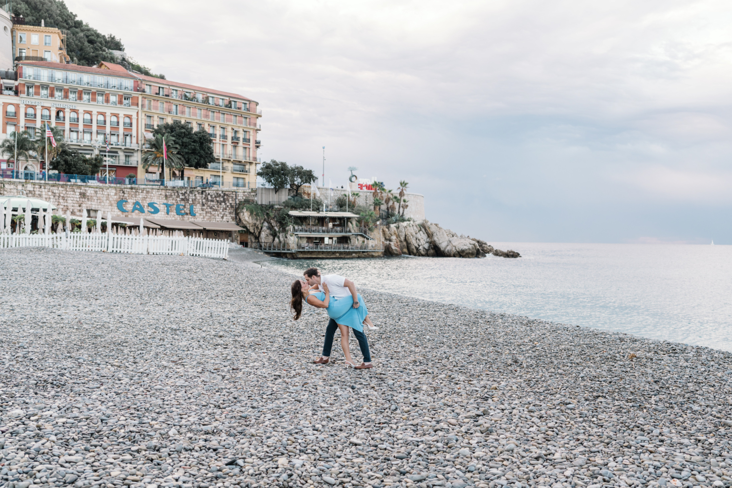 husband dips new wife on beach in nice france