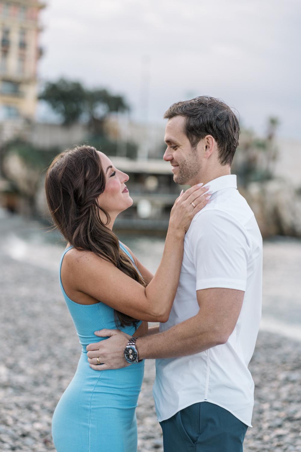 man and woman smile at each other on beach in nice france