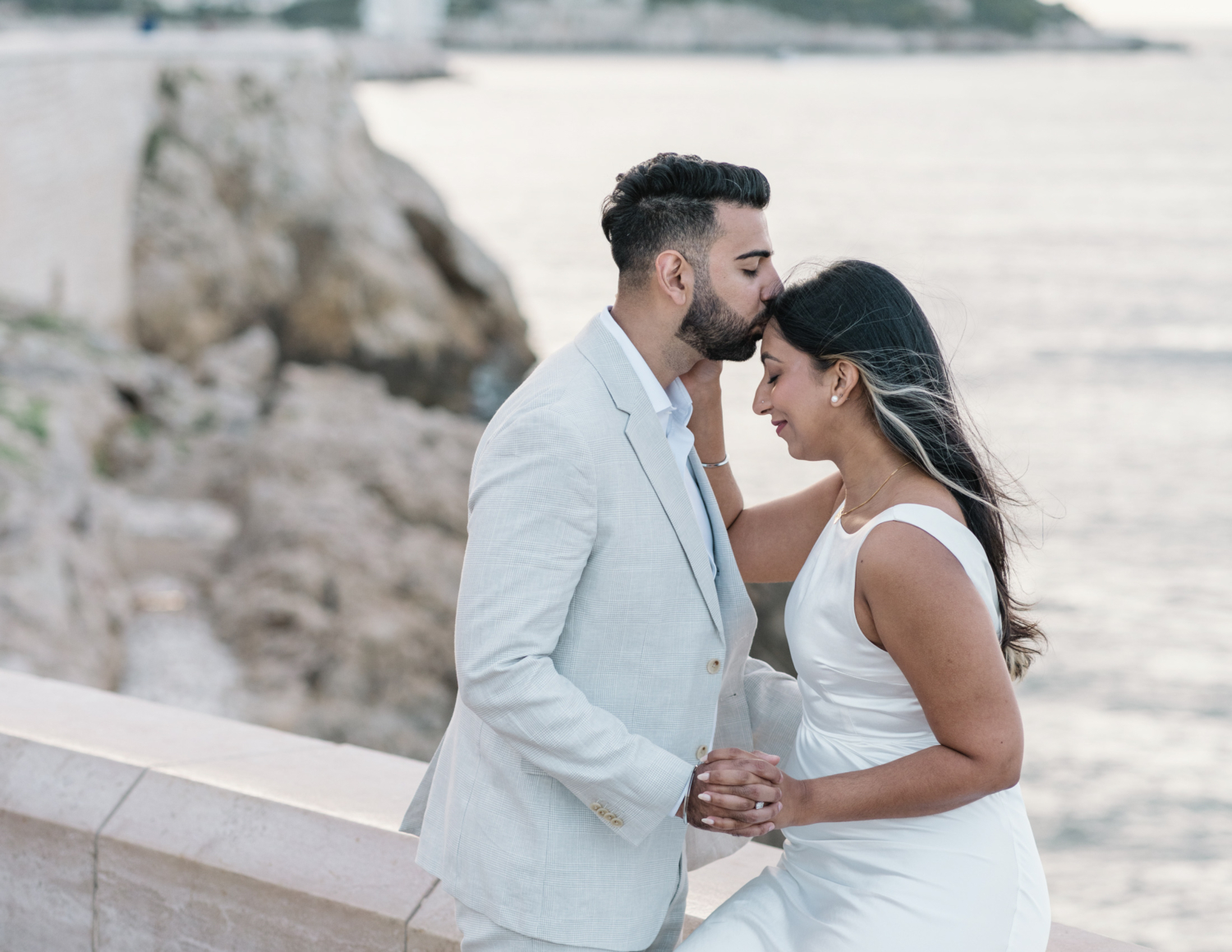 man kisses fiancee on forehead in nice france