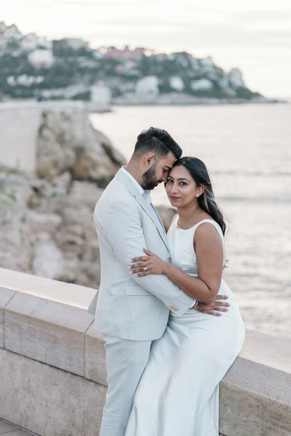 gorgeous engaged couple embrace on boardwalk in nice france