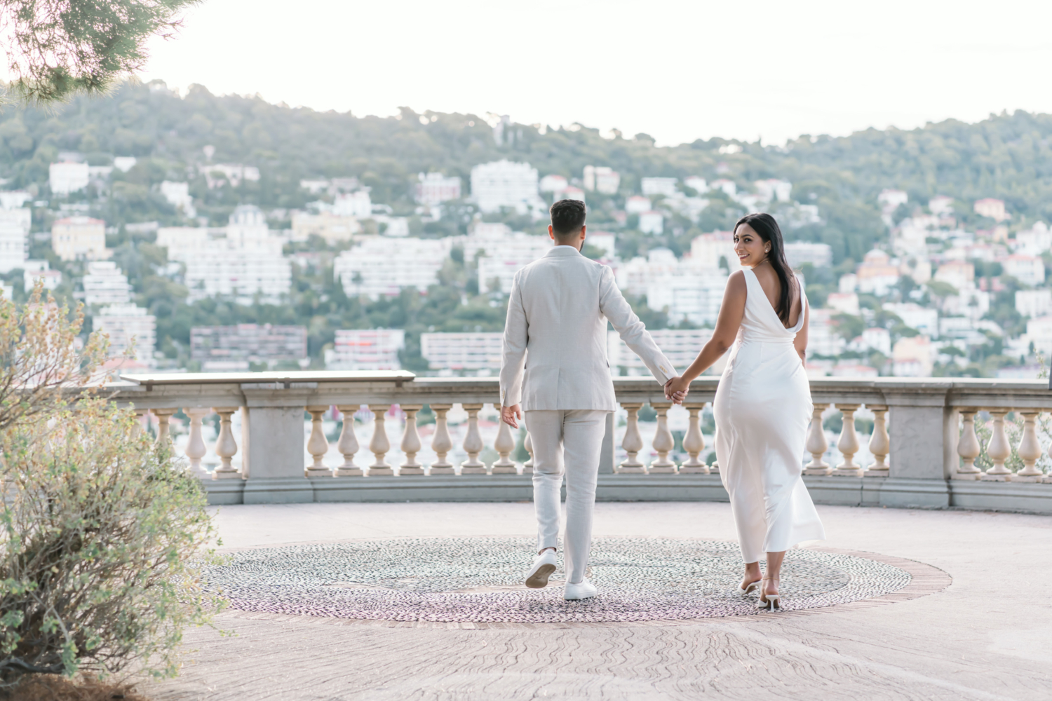 beautiful bride to be walks with handsome groom in nice france