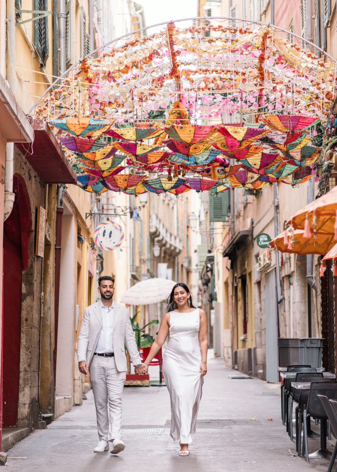 cute engaged indian couple walk in old town nice france