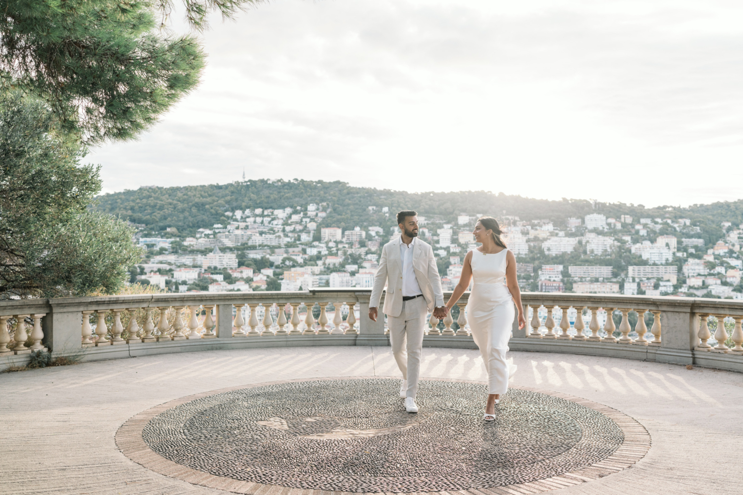 gorgeous engaged indian couple walk in the sun in nice france