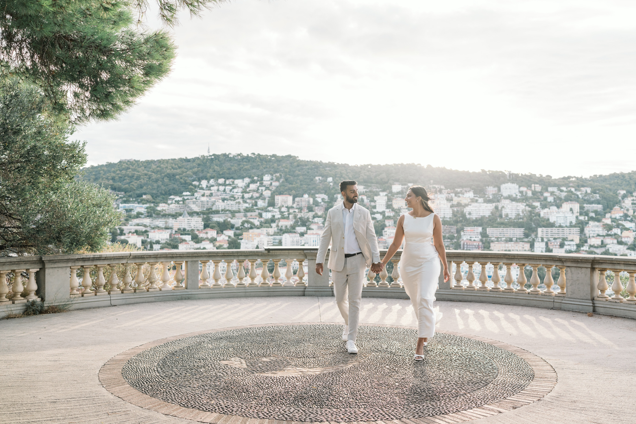 gorgeous engaged indian couple walk in the sun in nice france