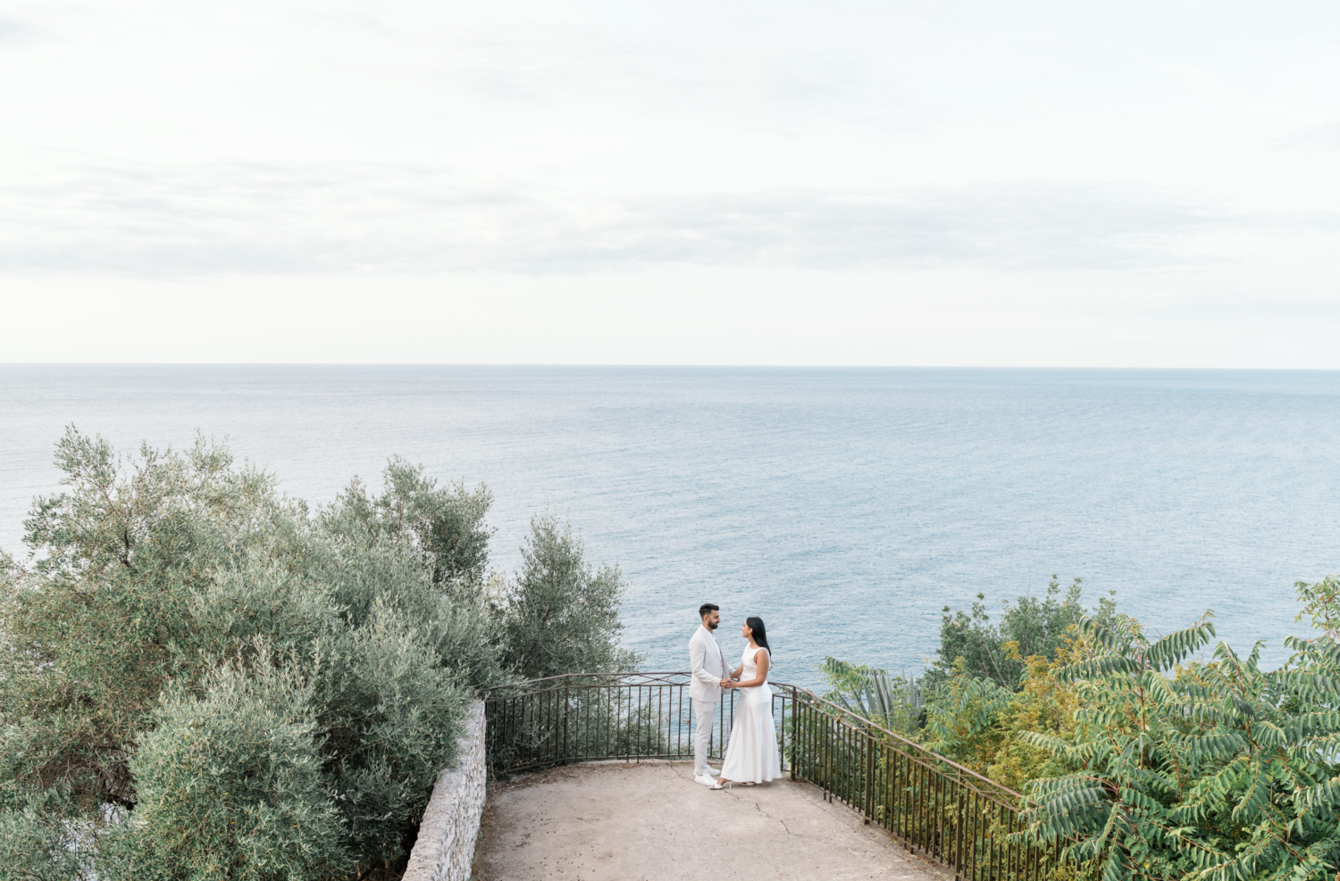 indian couple pose with view of blue sea in nice france