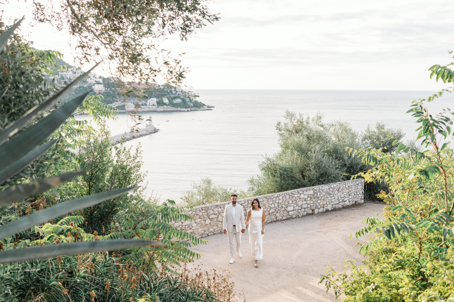 beautiful indian couple walk hand in hand in sunny nice france