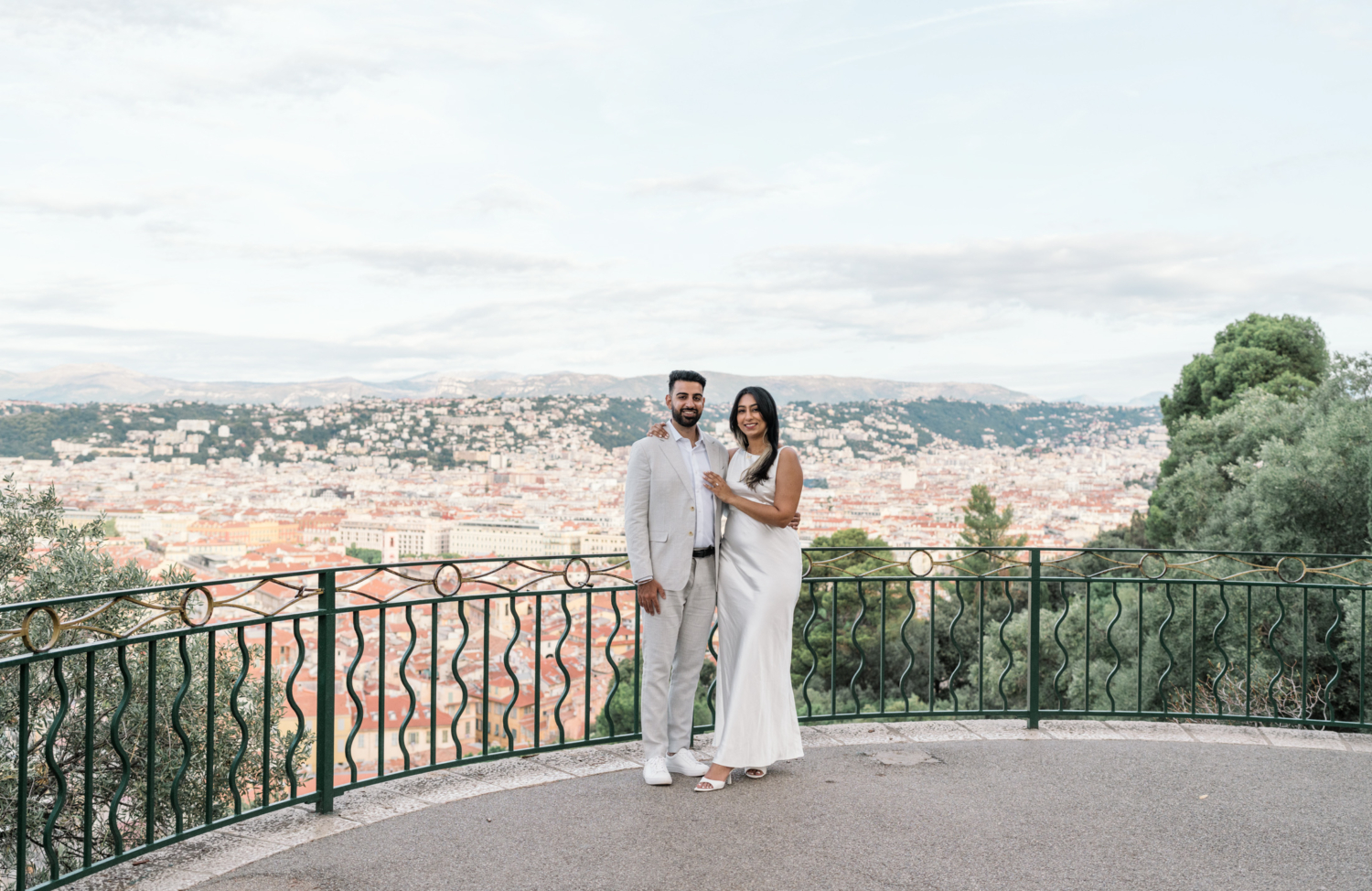 gorgeous indian american couple pose with view of old town in background in nice france