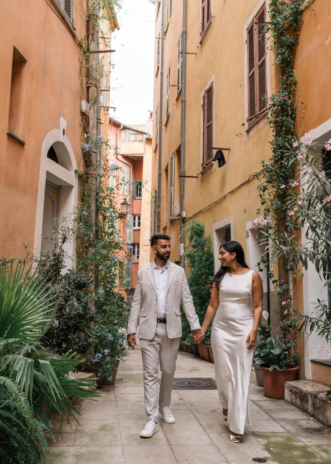 indian american couple walk hand in hand in colorful nice france