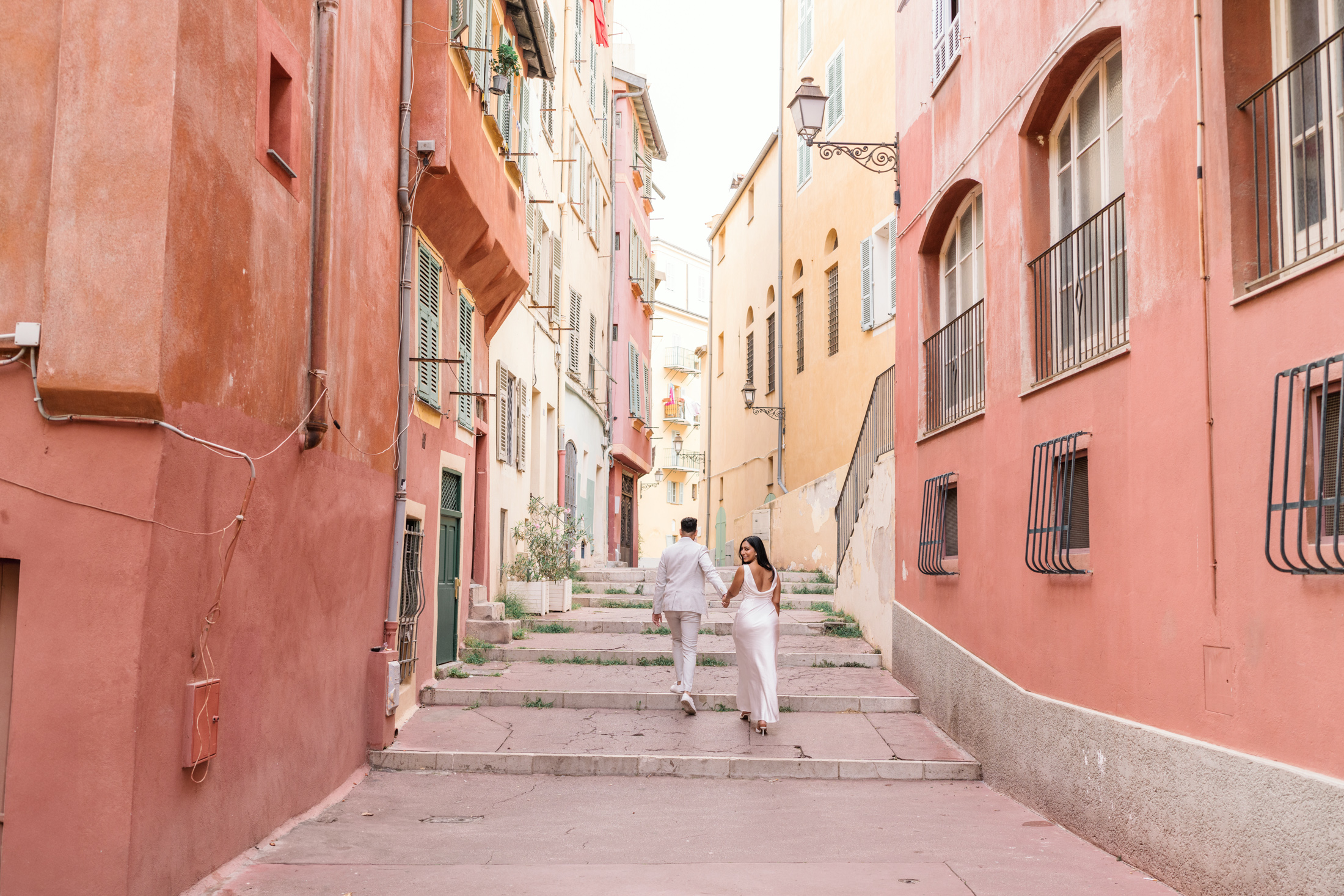 woman looks to camera walking in old town nice france