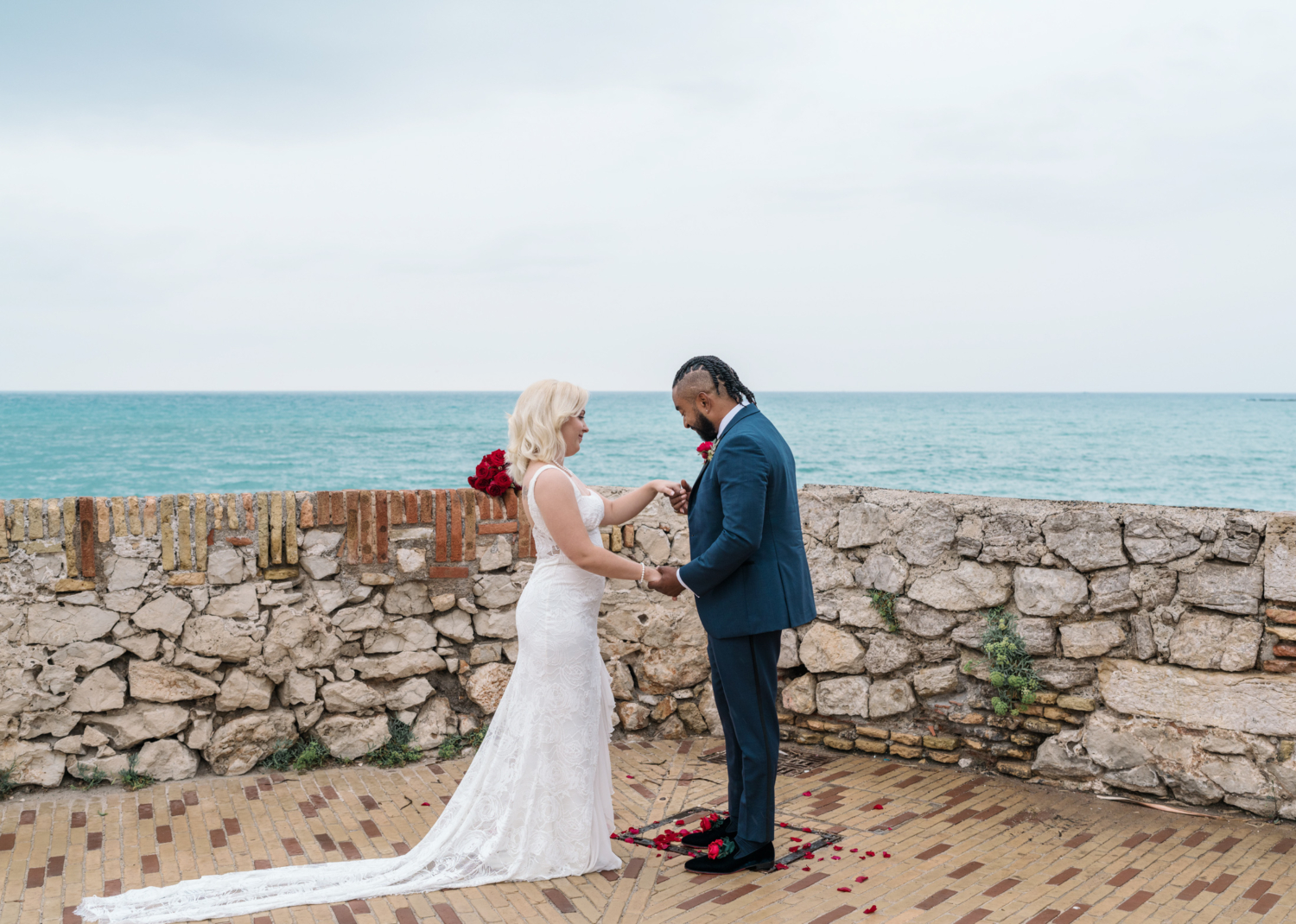 groom holds brides hand during elopement ceremony in antibes france