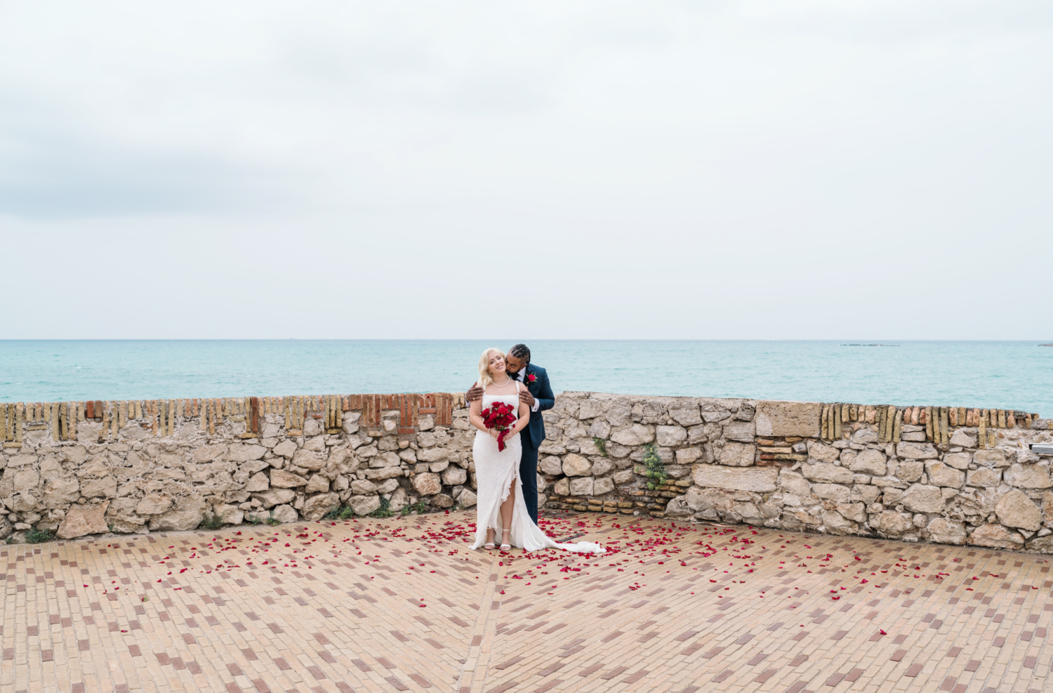 groom kisses bride on neck after their wedding ceremony in antibes france