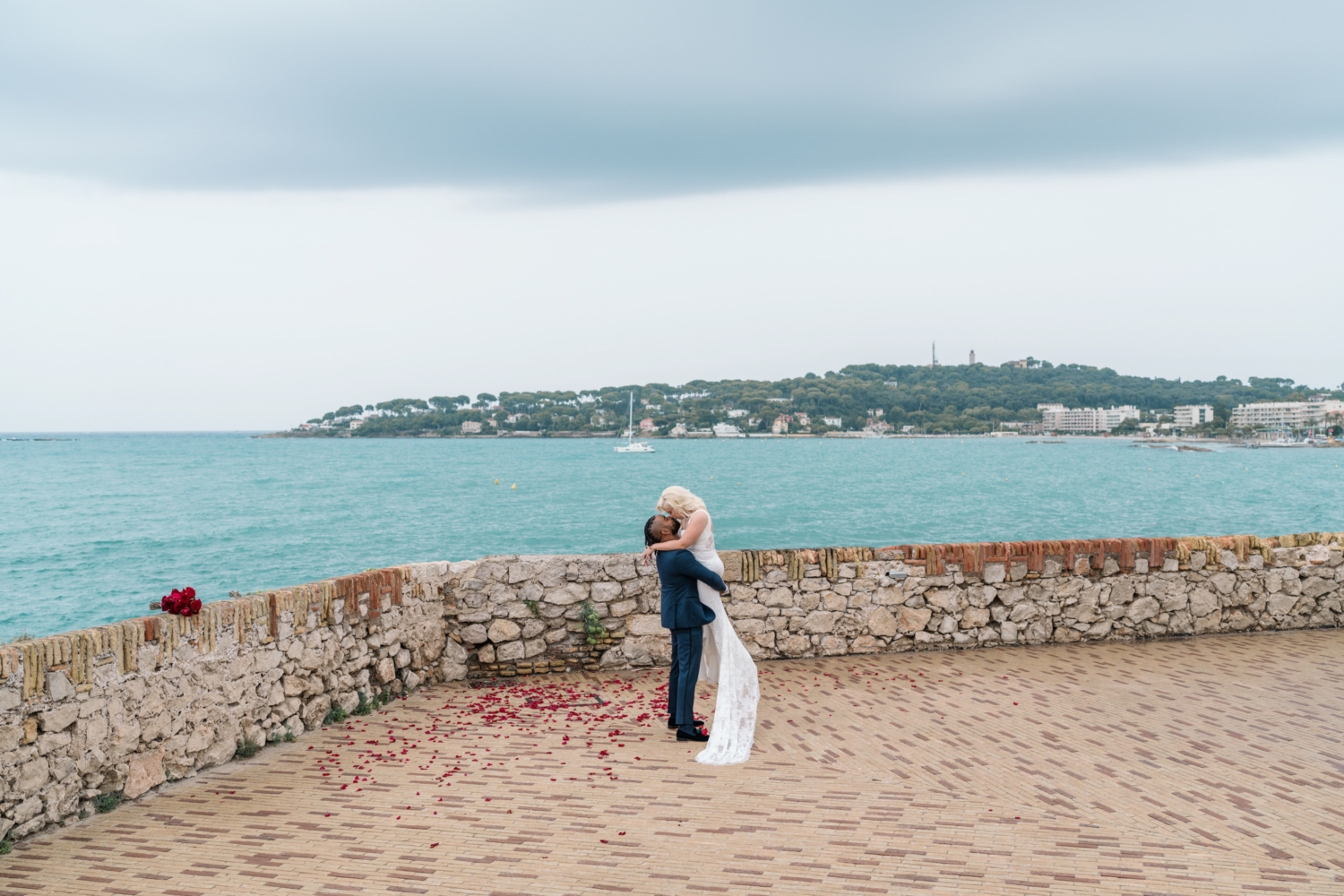 groom lifts bride after wedding ceremony in antibes france