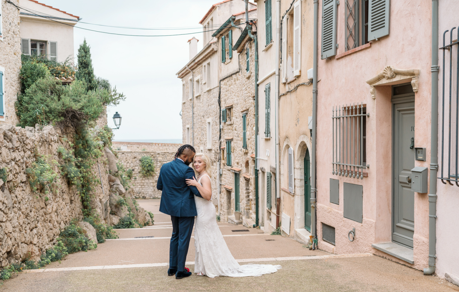 bride and groom embrace in old town antibes france after their wedding