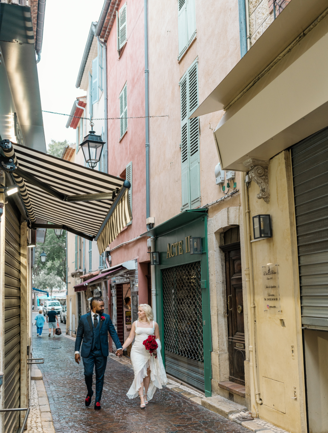 bride and groom walk through the streets of old antibes france