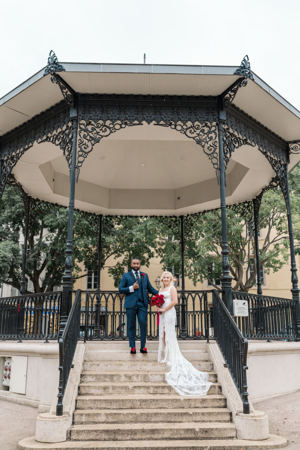 bride and groom pose under pavilion in antibes france