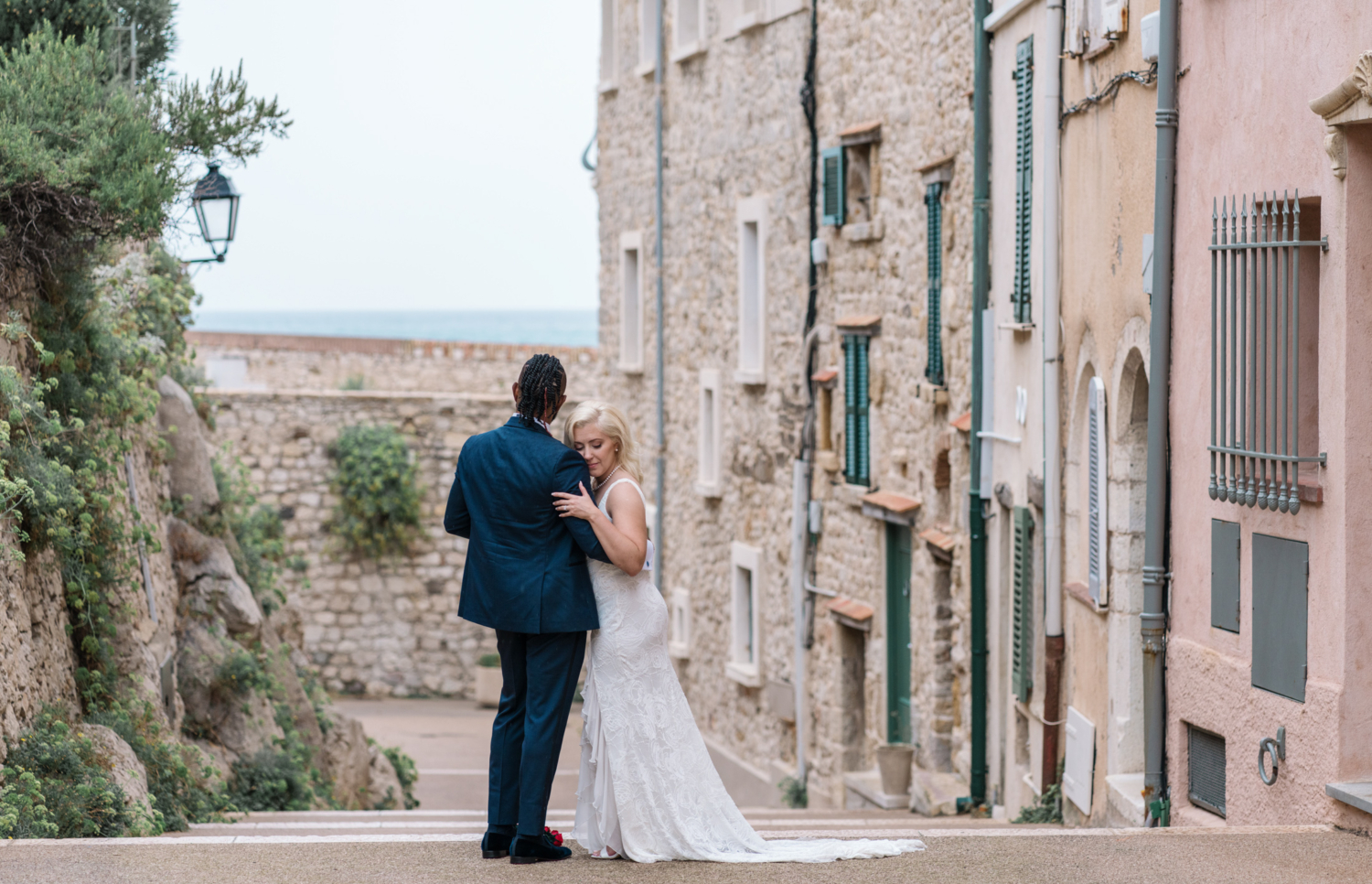 bride and groom embrace in old town antibes france