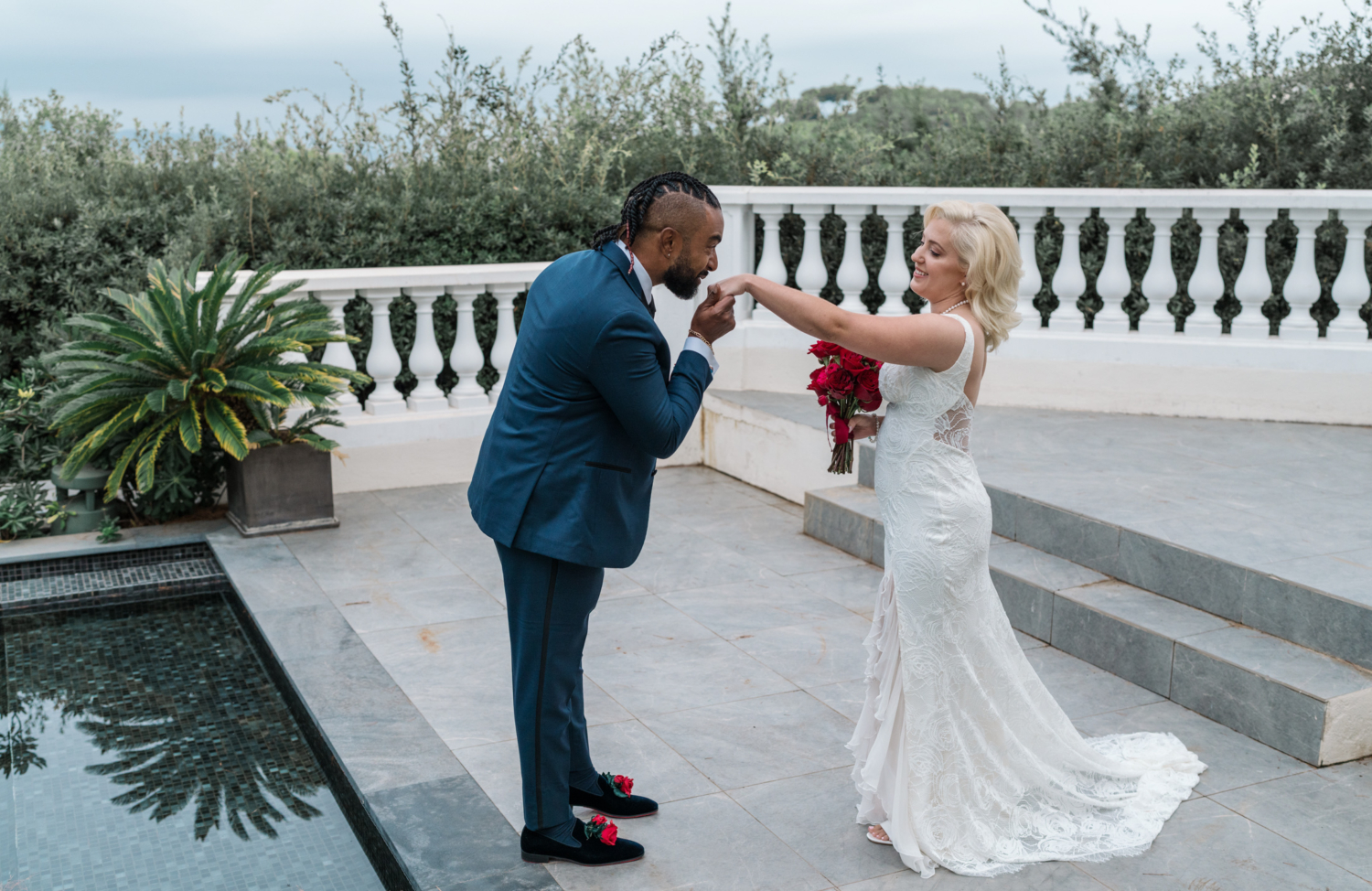 groom kisses hand of bride before wedding ceremony in antibes france