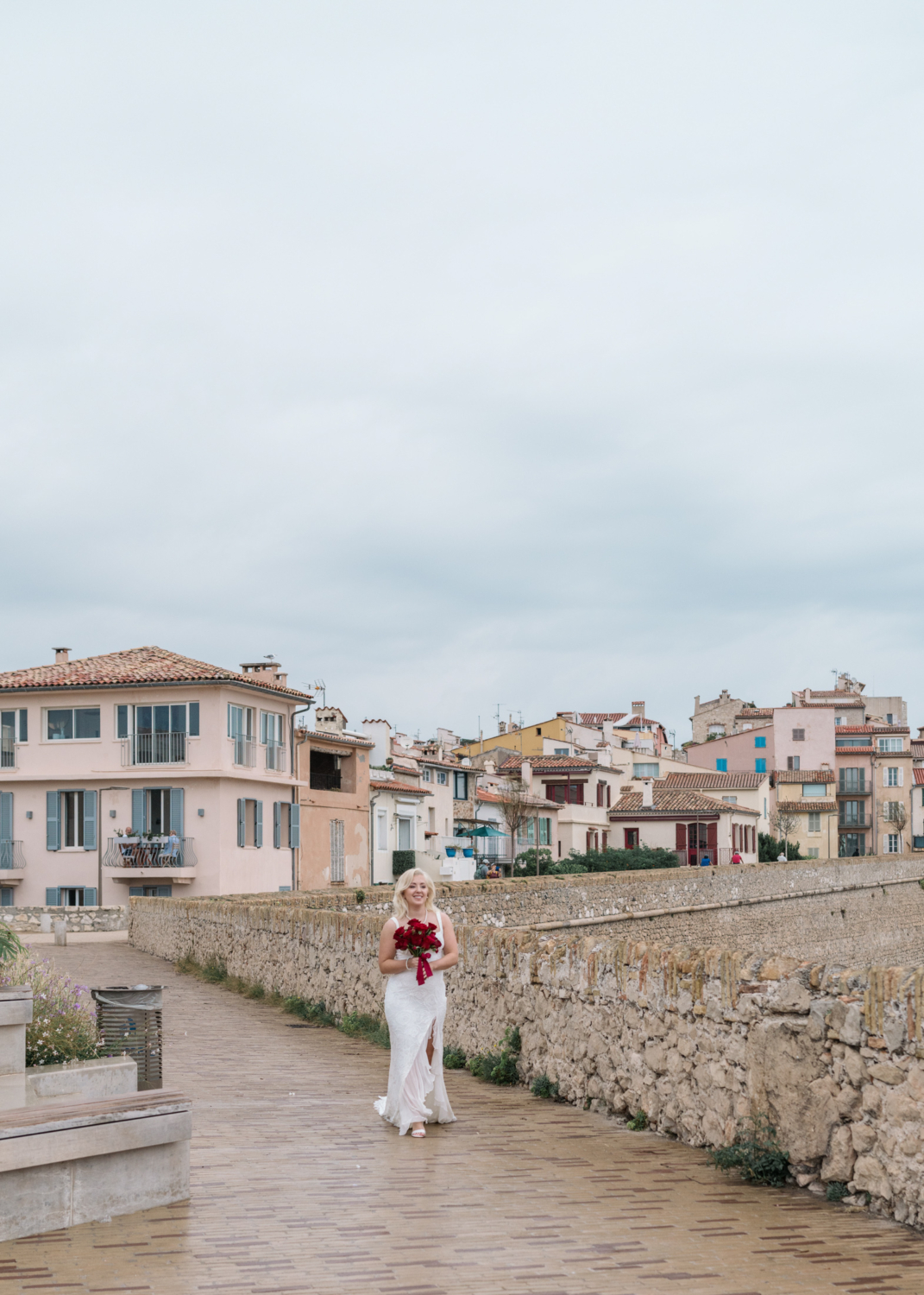 bride walks down the aisle to her wedding ceremony in antibes france