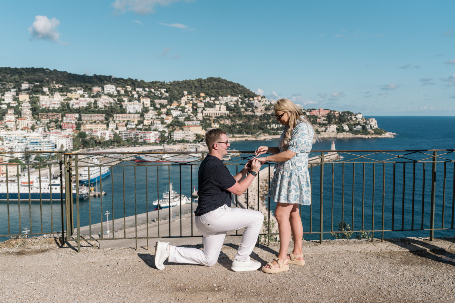 man gives engagement ring to woman with view of sea in nice france