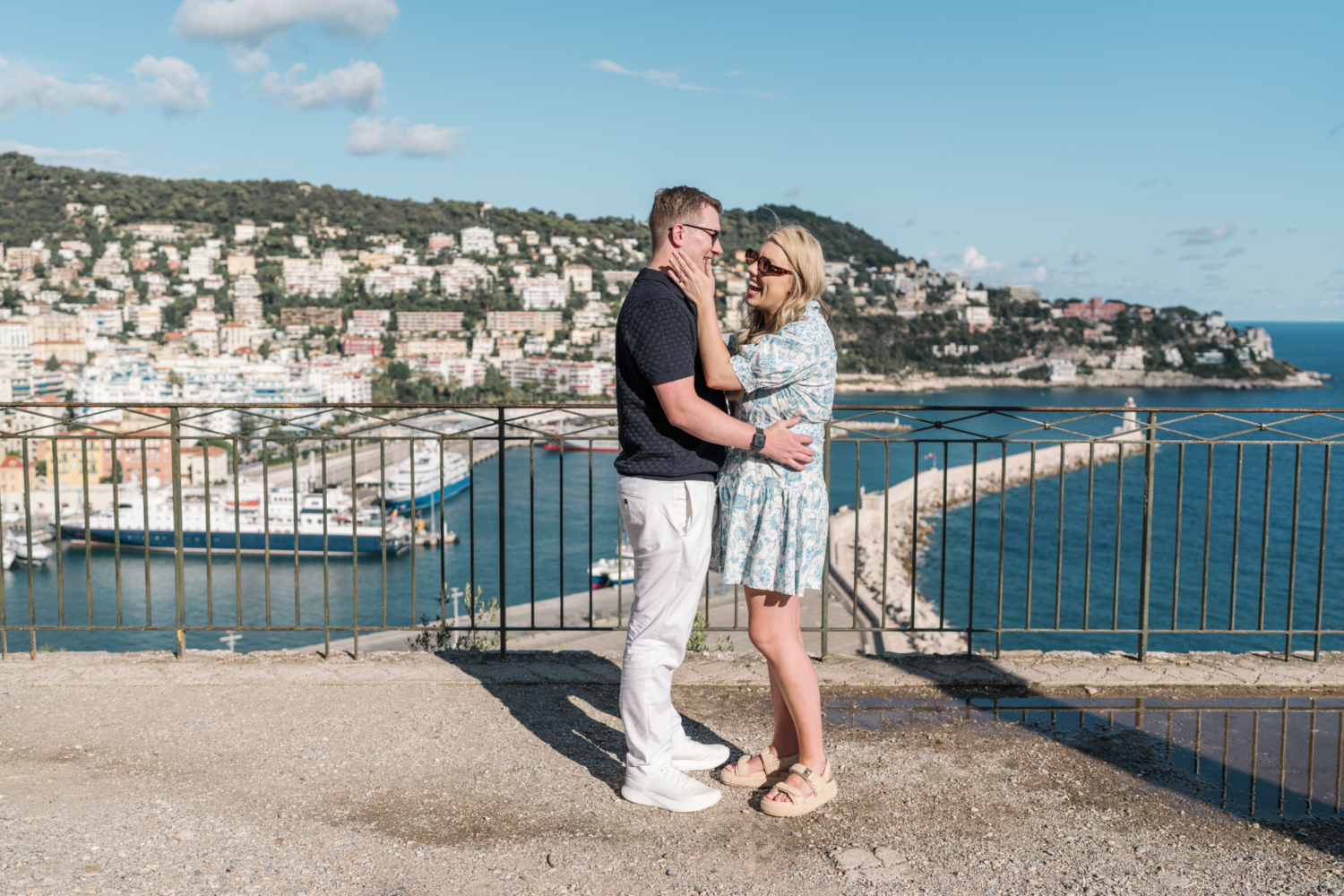 woman laughs after man proposes with view of sea in nice france