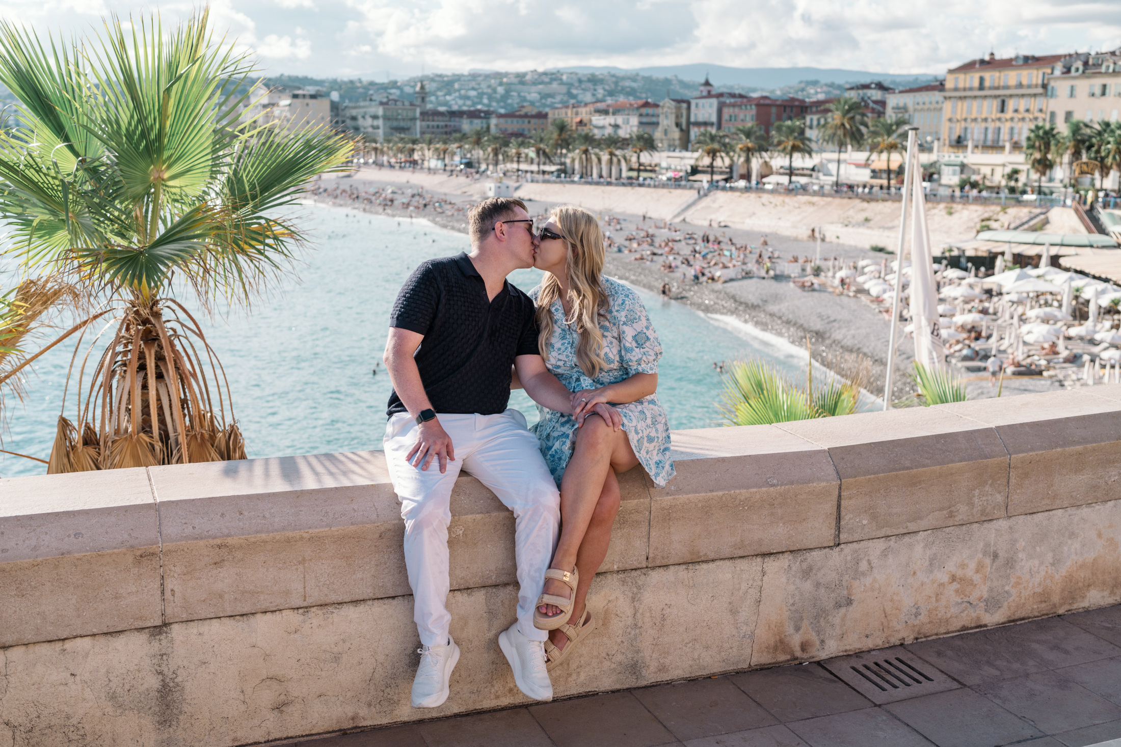 newly engaged couple kiss with view of sea in nice france