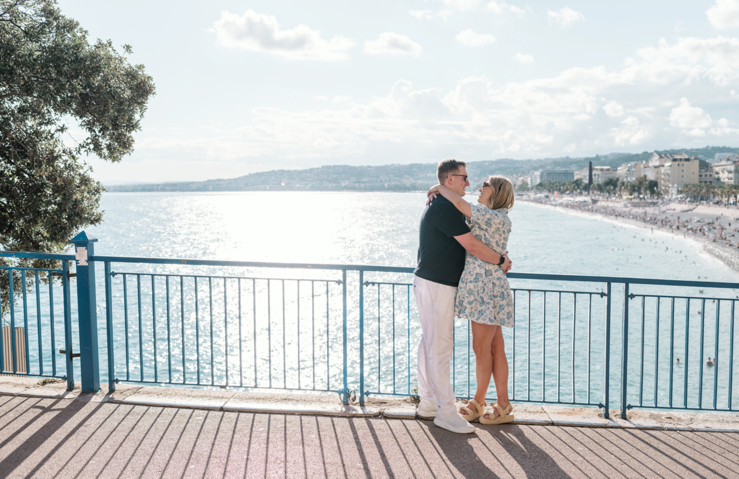 newly engaged couple hug in nice france with view of the sea