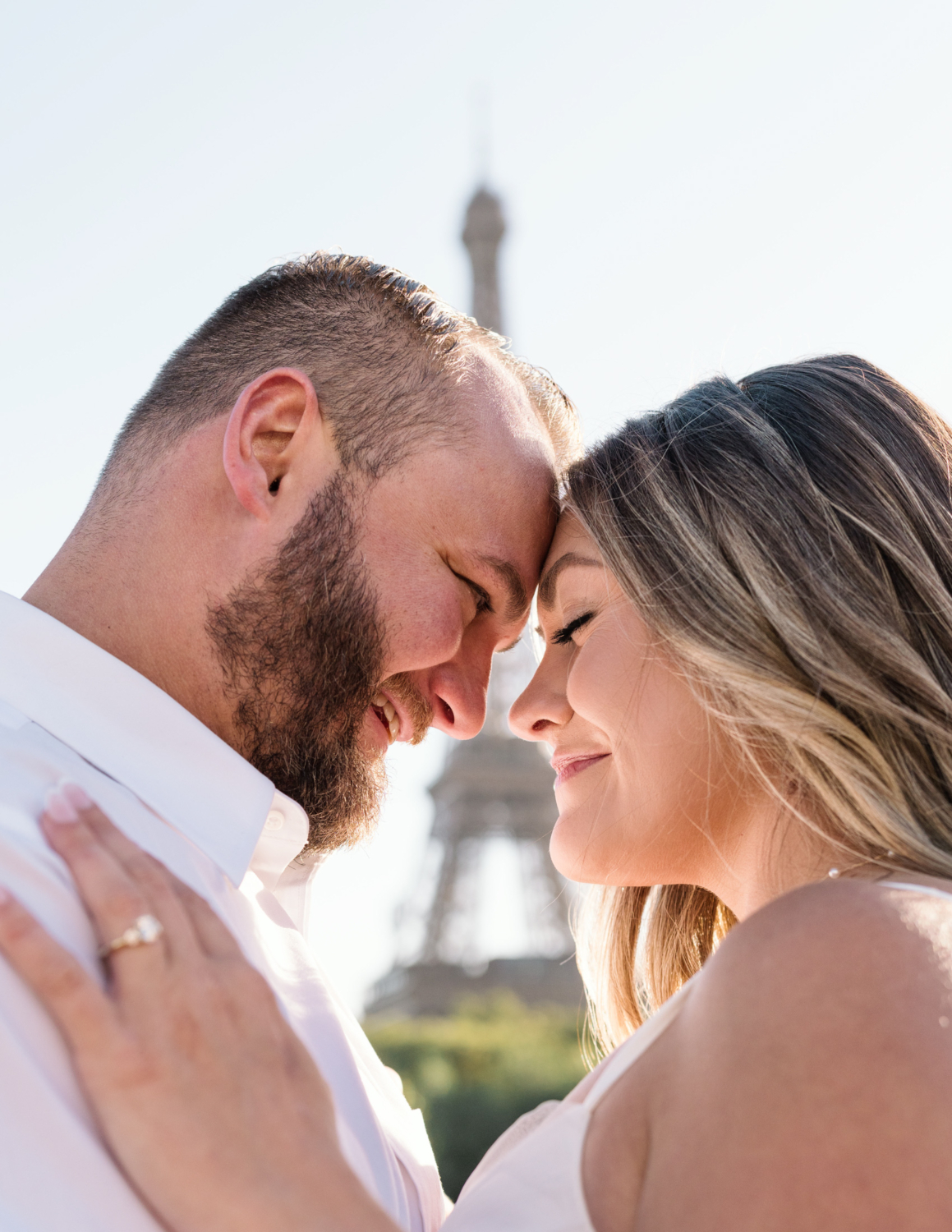 cute couple embrace with eiffel tower between them in paris france