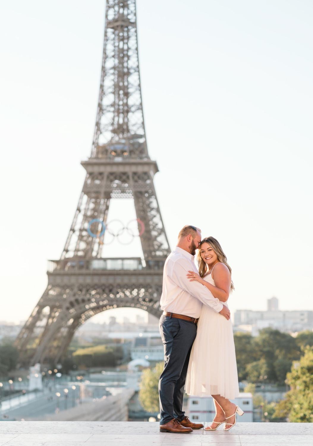 cute couple cuddle with view of eiffel tower in paris france