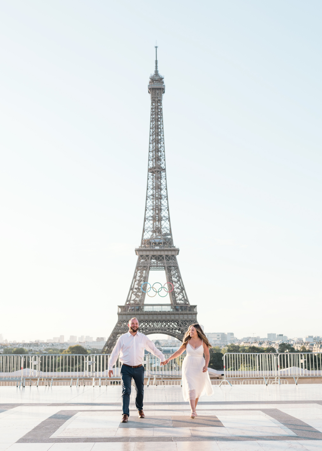 happy couple walk together with view of eiffel tower in paris france