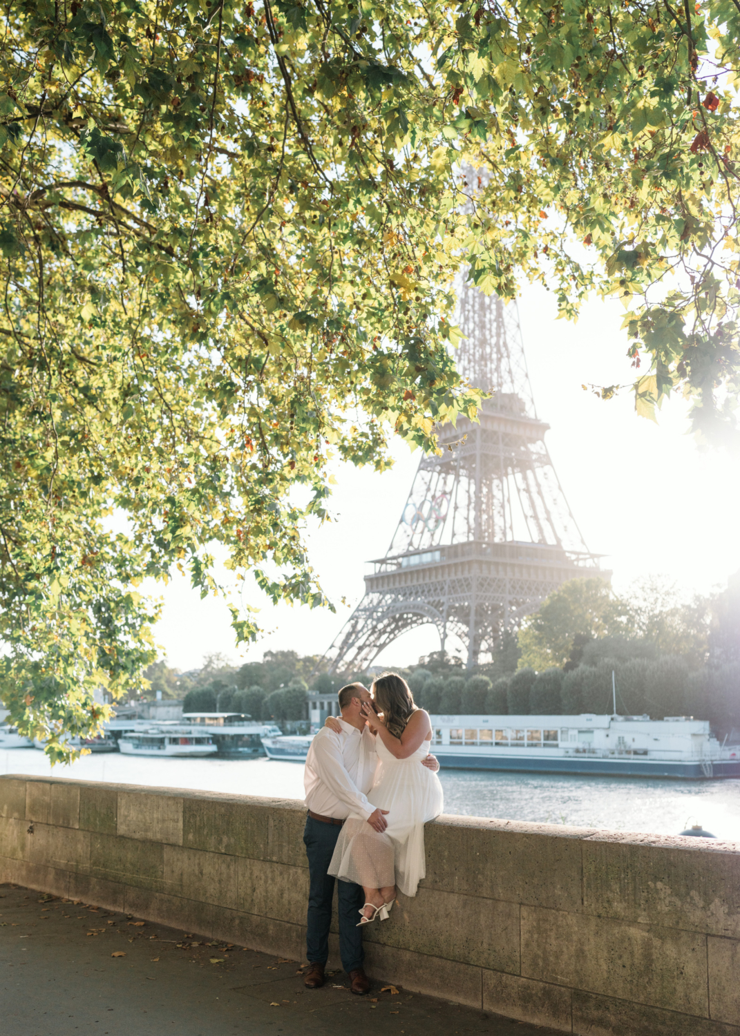 couple kiss passionately with view of eiffel tower in paris france