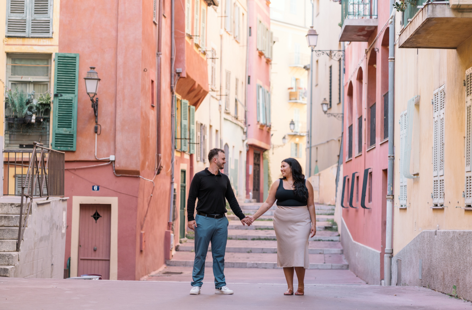 newly engaged couple hold hands in beautiful old town in nice france