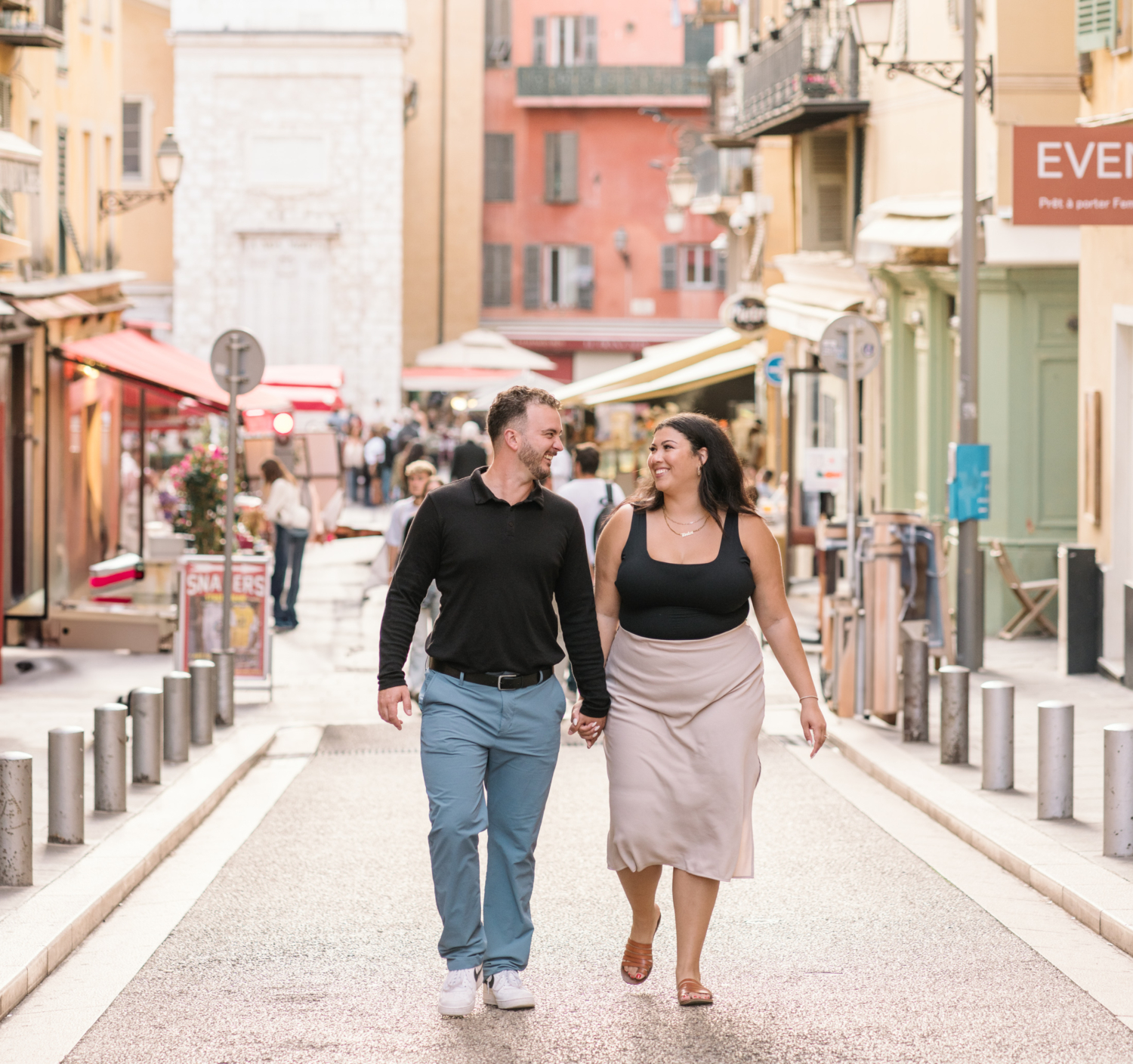 cute couple walk hand in hand in old town nice france