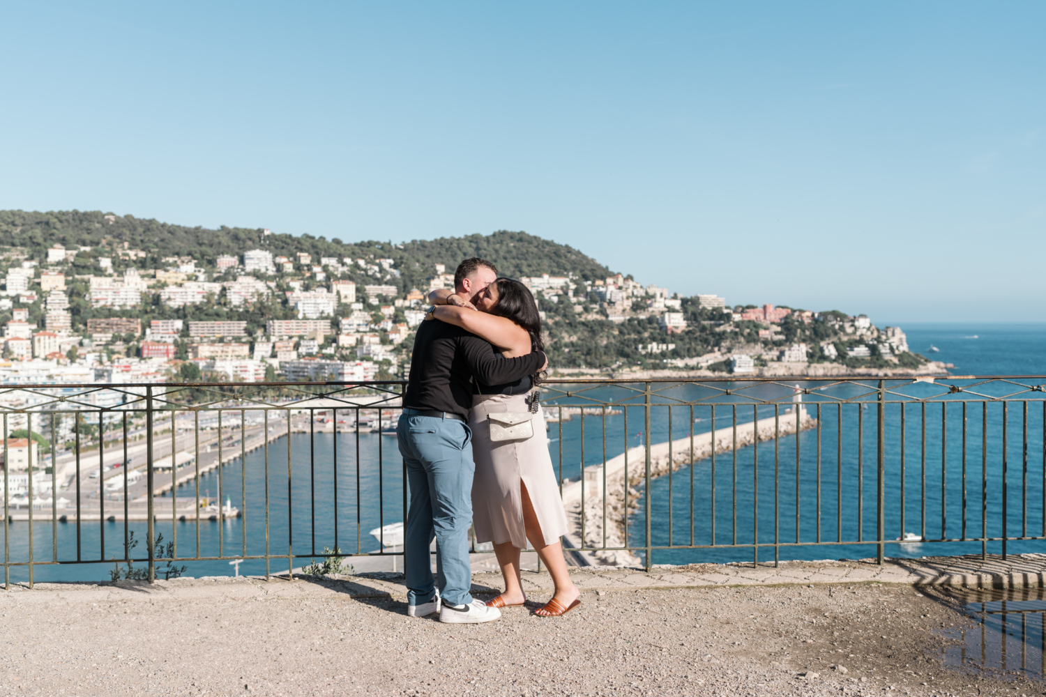 woman hugs man after their engagement in nice france