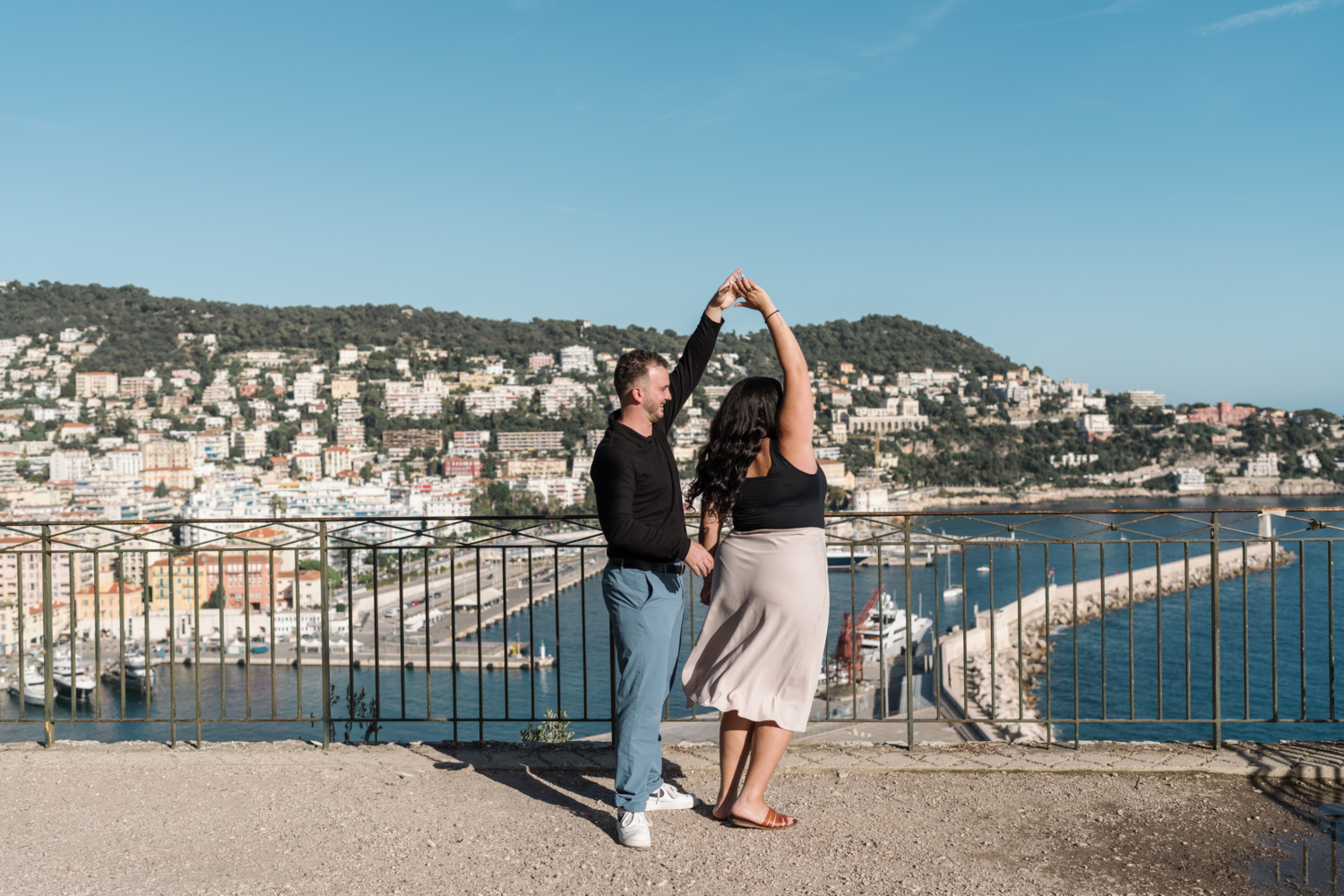 man twirls woman in celebration after their engagement in nice france