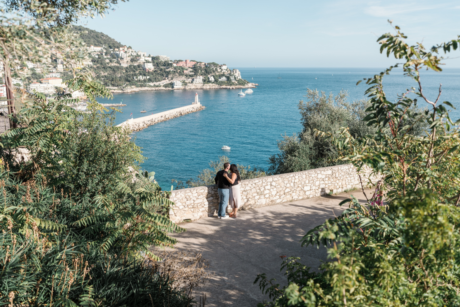 newly engaged couple in nice france embrace with a view of the sea