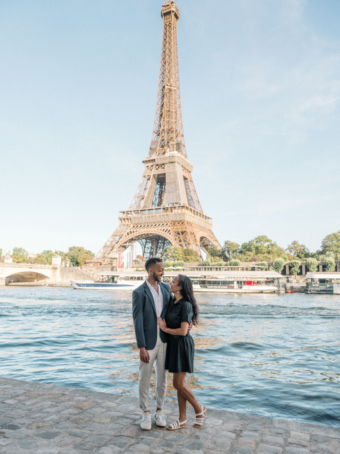 newly engaged african american couple smile after their engagement in paris