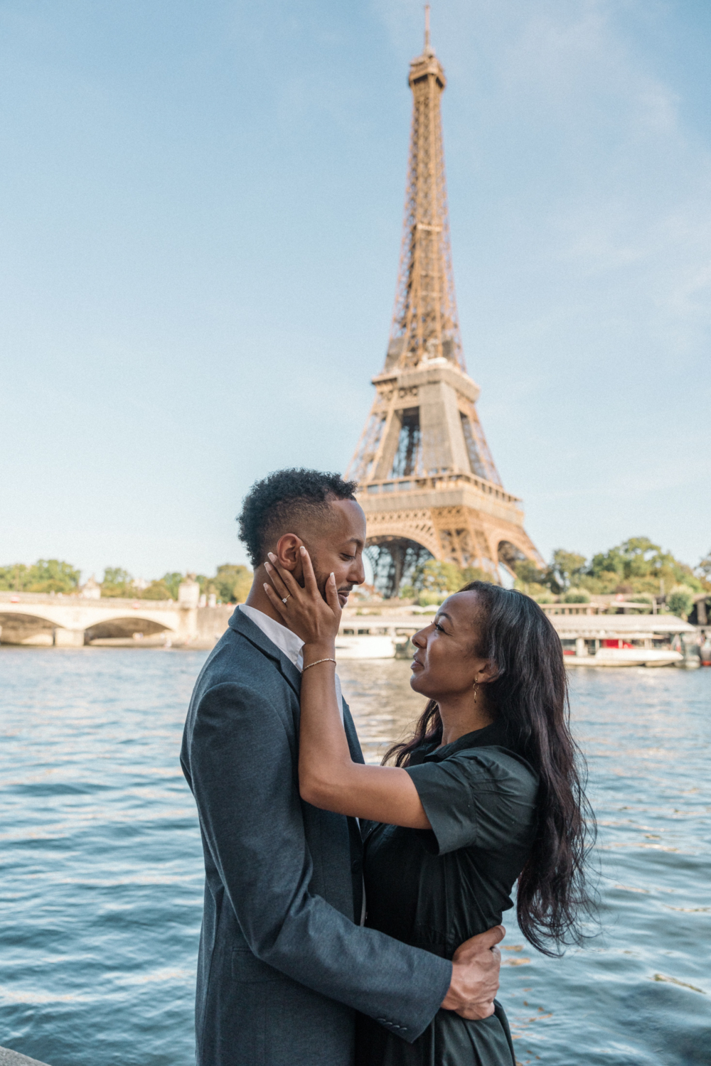 newly engaged african american couple smile at each other in paris france