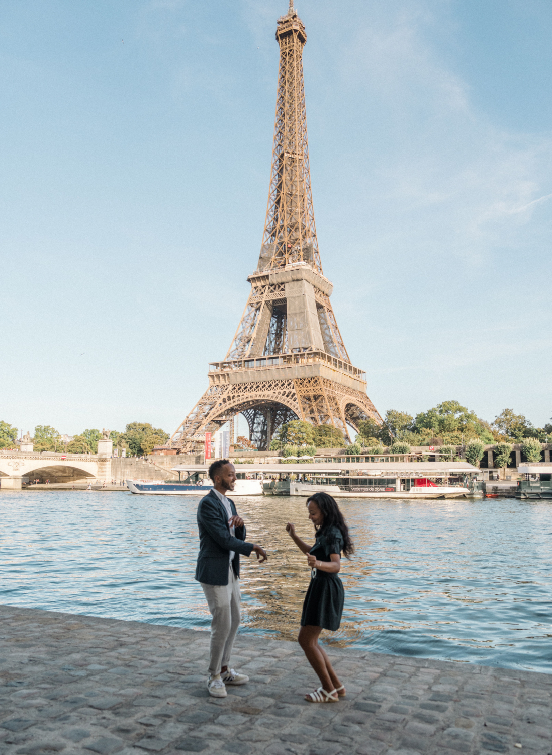 newly engaged african american couple dance at the eiffel tower