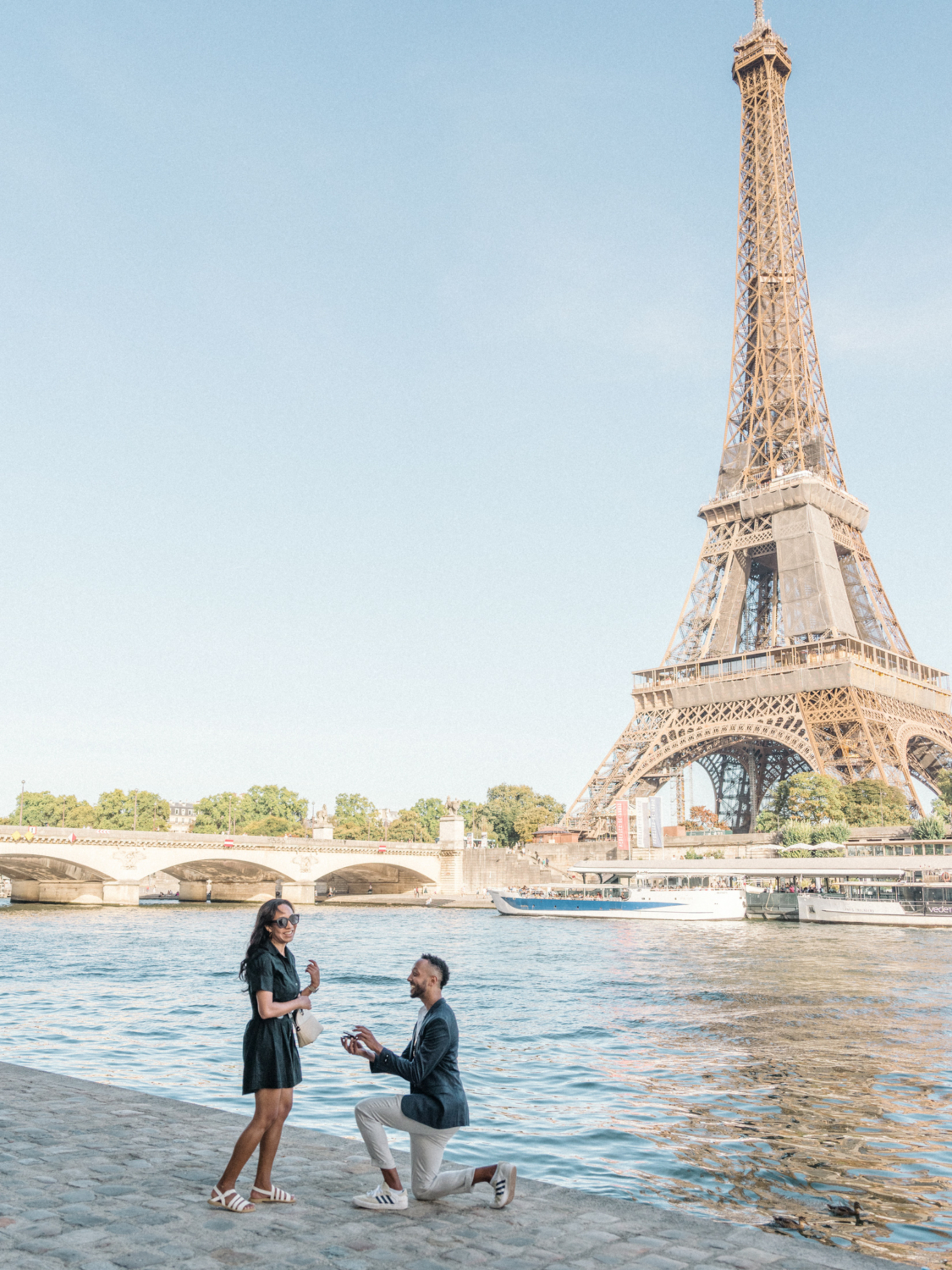 man proposes to woman with diamond ring at the eiffel tower in paris