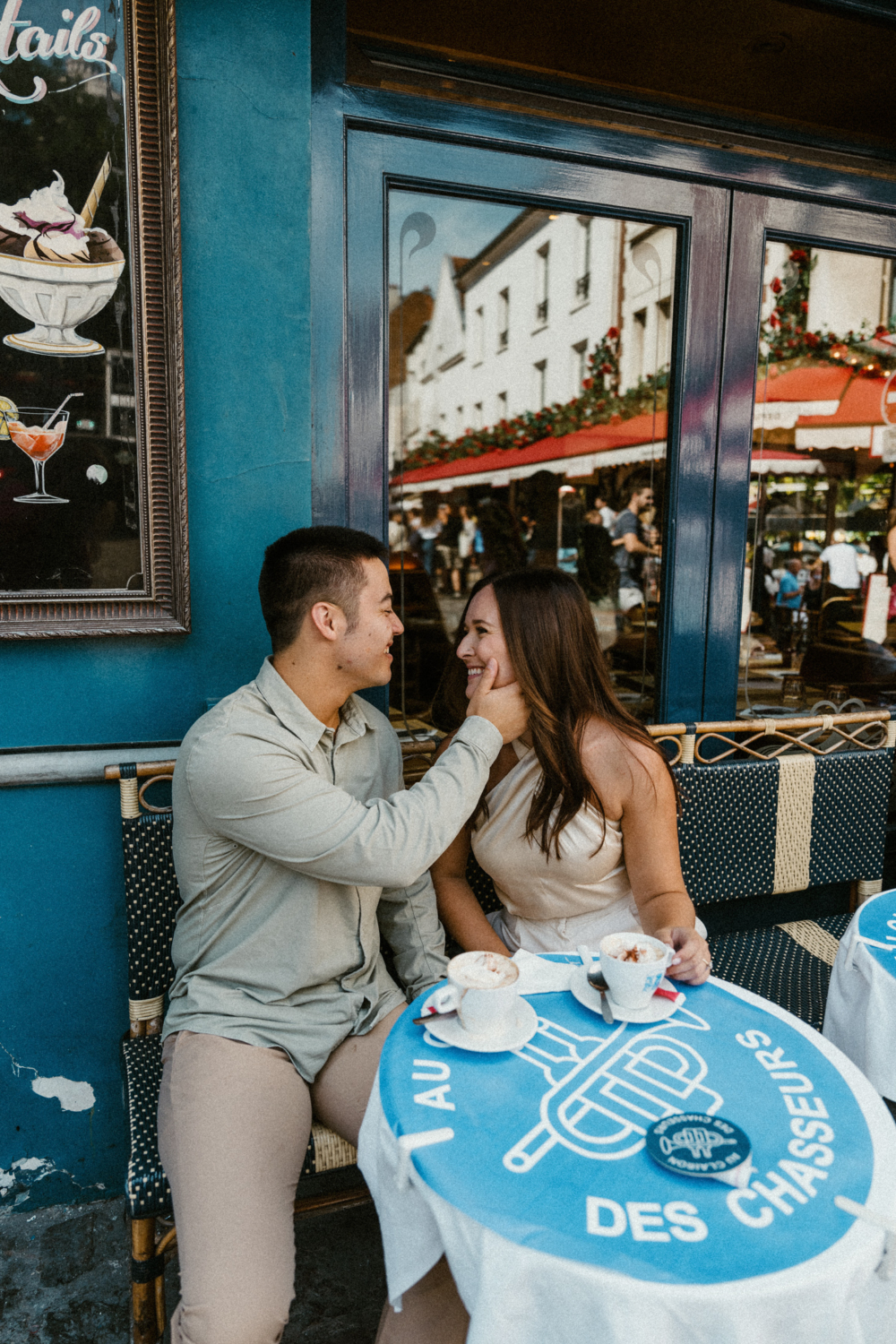 engaged couple share coffees in paris in montmartre