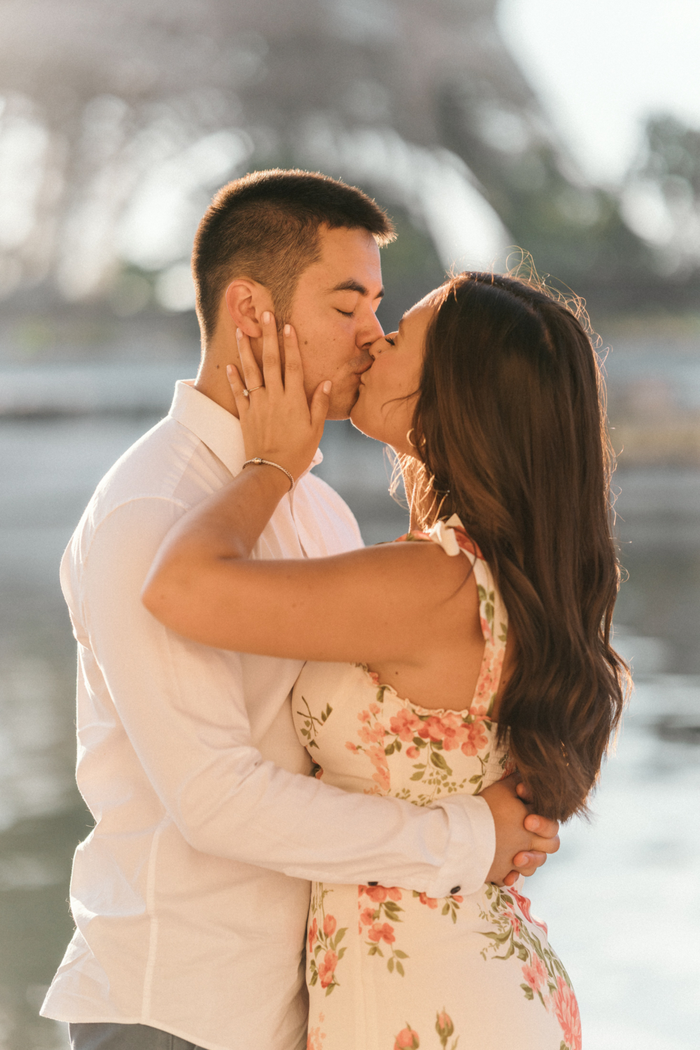 engaged woman gives her fiance a kiss with the eiffel tower in the background in paris