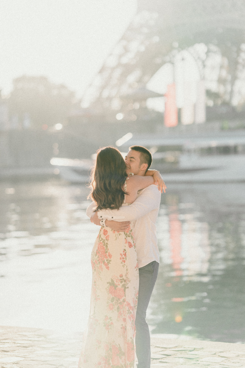 man embraces woman in the sunshine in paris