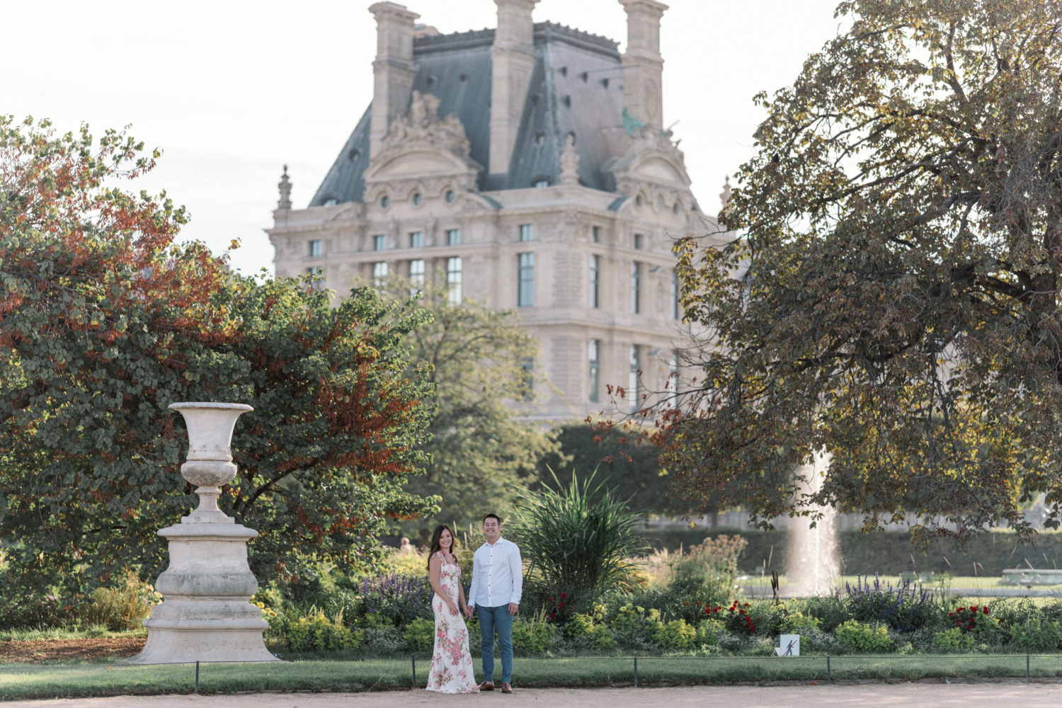 engaged couple pose in the tuileries gardens in paris france