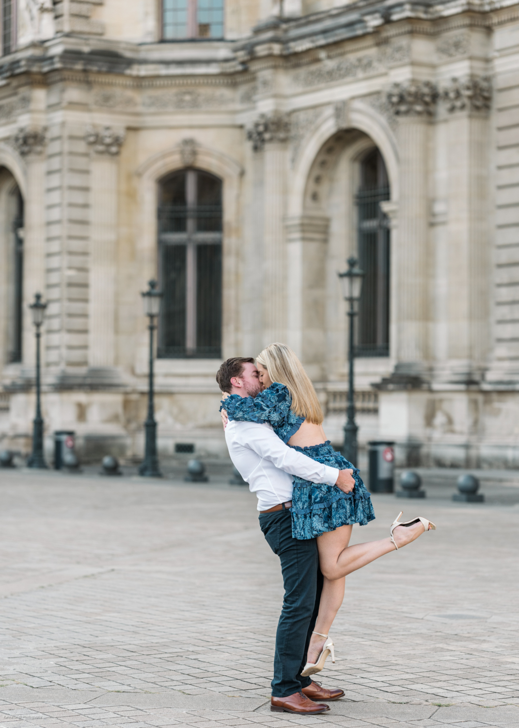 man lifts woman in air during engagement photoshoot in paris