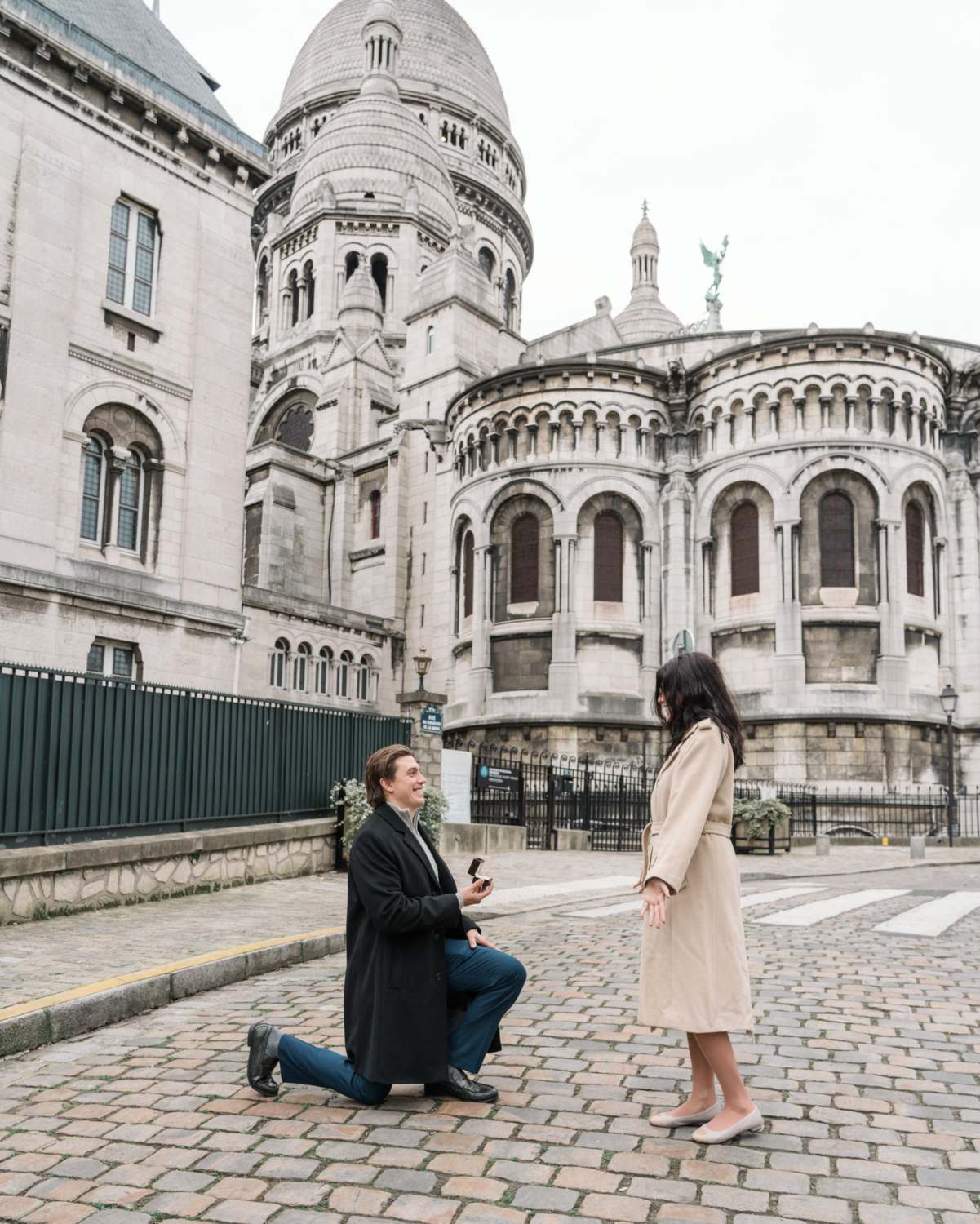 man presents engagement ring to woman in montmartre in paris