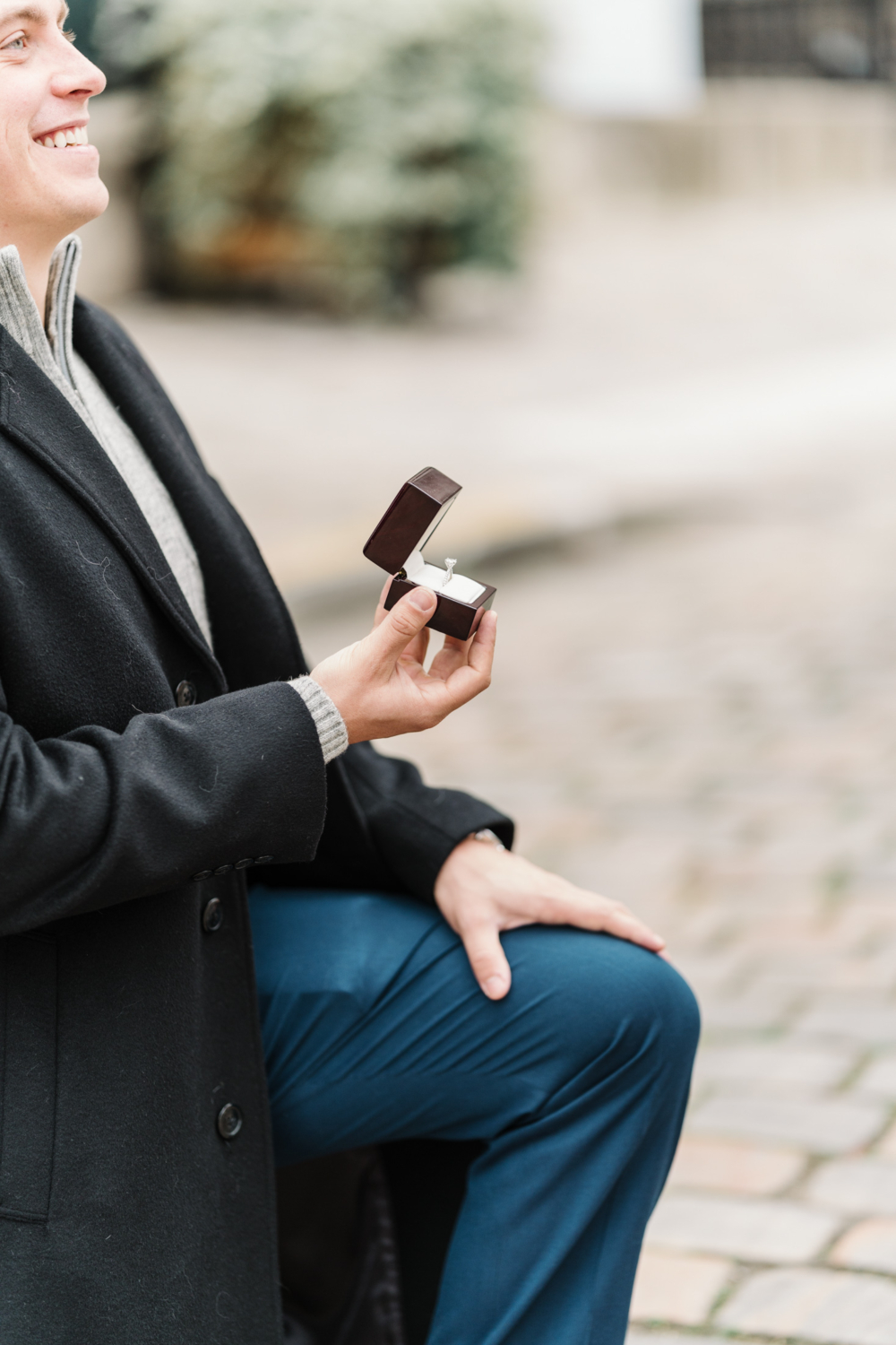 man presents diamond ring to woman in paris france