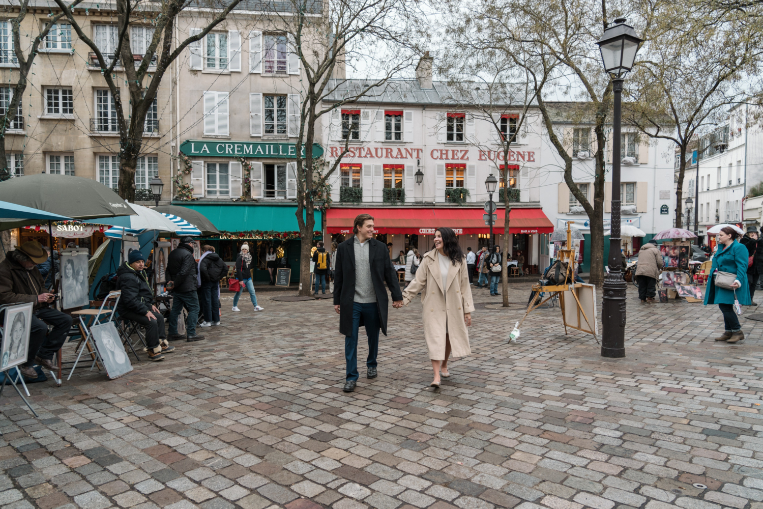 newly engaged couple walk hand in hand through montmartre paris france