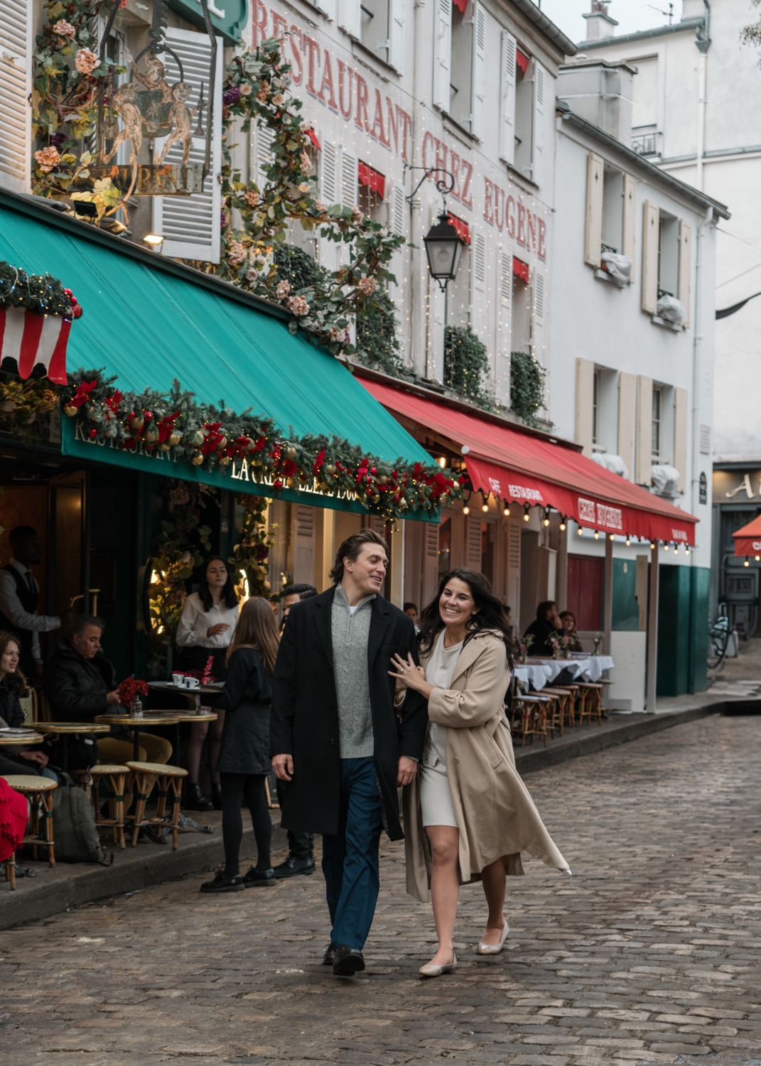 happy newly engaged couple walk through paris during the holidays in paris