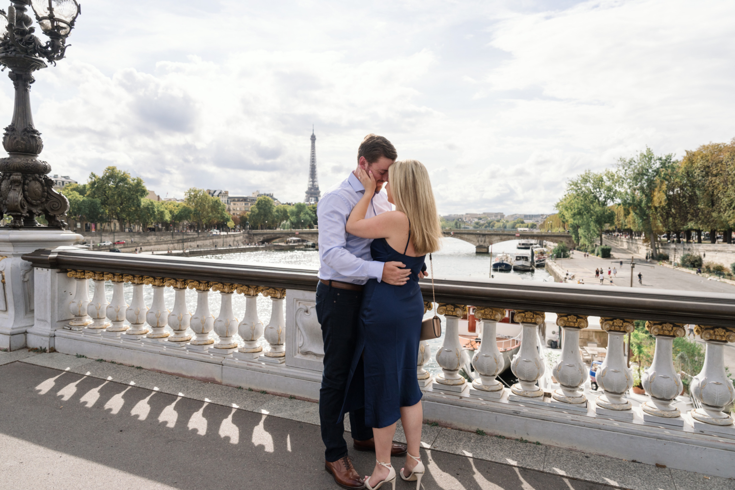 newly engaged couple look in to each other's eyes on pont alexandre in paris